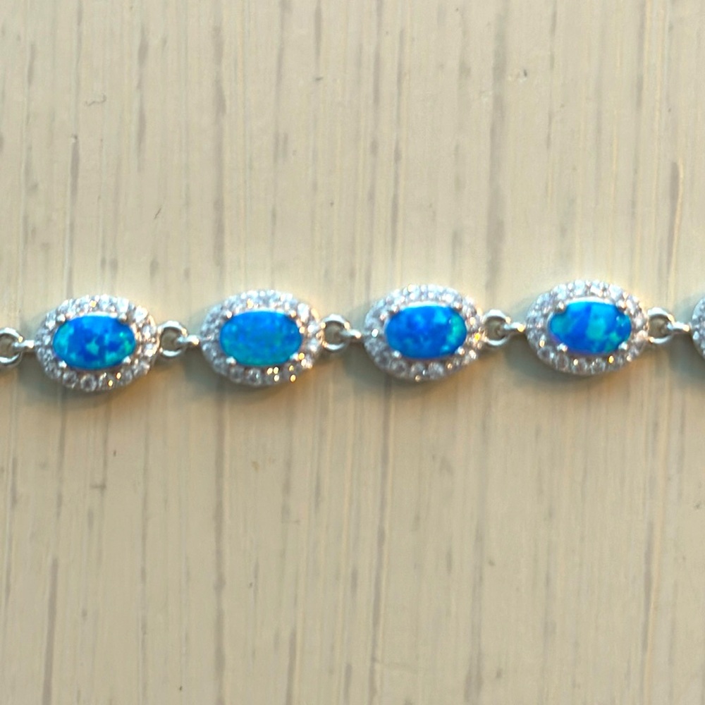 Halo style blue opal and white topaz tennis bracelet set in sterling silver. NWT